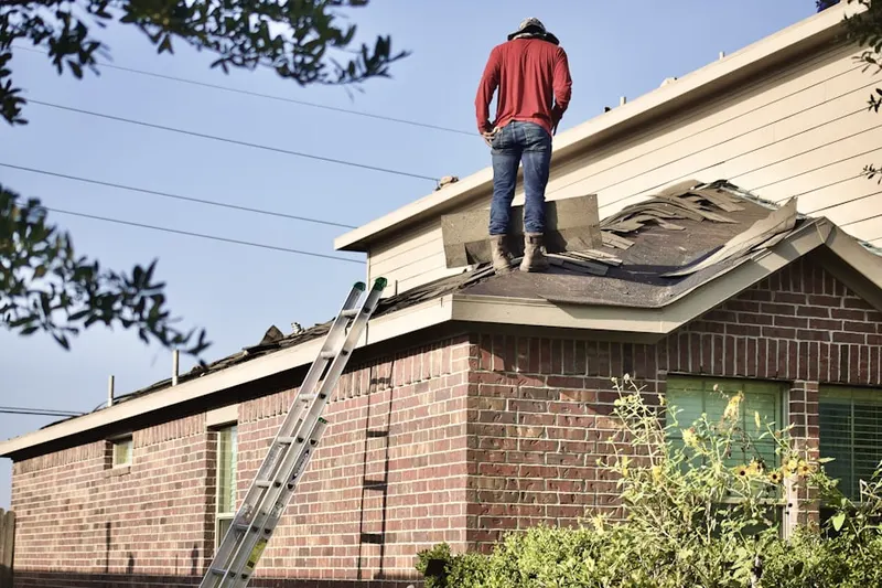 Professional roofer working on a residential roof in Meeting House Hill